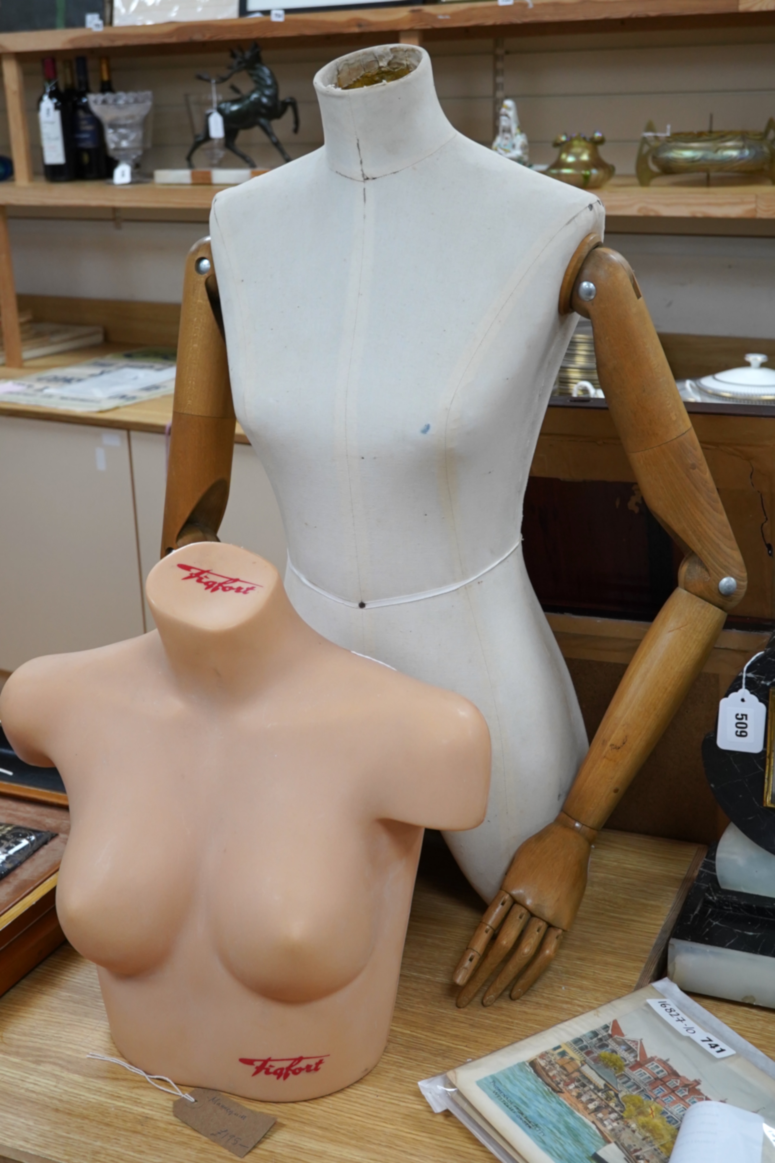 An unusual half female mannequin (cloth covered) with carved wooden jointed arms, hands and fingers, together with a female bust, by Figfort, mannequin 72 cm high. Condition - both good